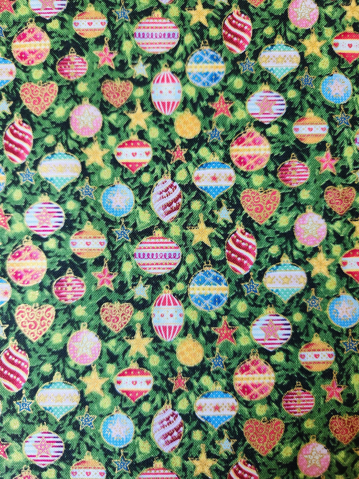Christmas fabric. Green background with christmas tree decorations accented with gold
