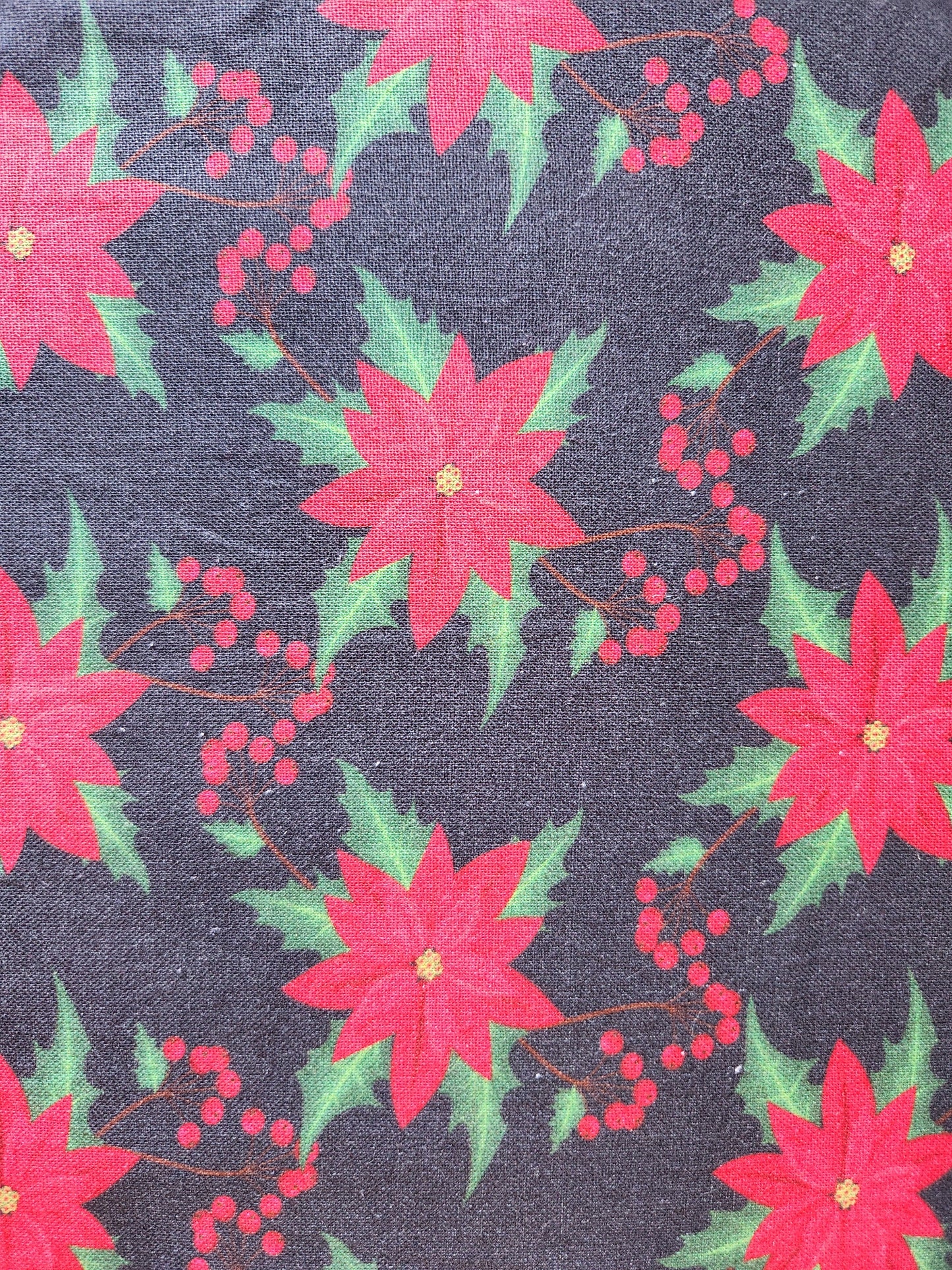 Christmas fabric.   Black background with red poinsettia