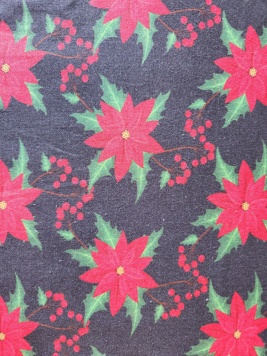 Christmas fabric.   Black background with red poinsettia