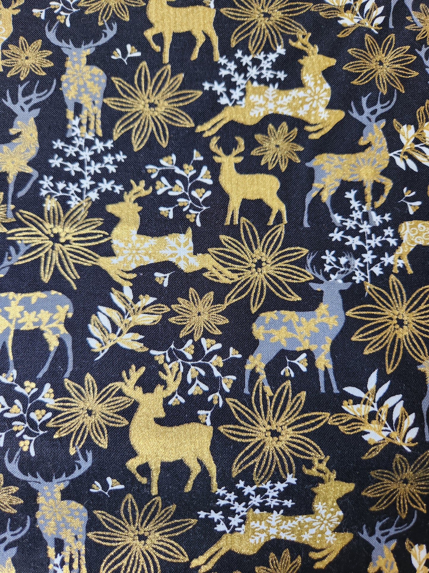 Christmas fabric - black background with white and gold reindeer and floral accents